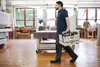 A man walks through a workshop carrying a toolbox. Anteprima dell’immagine prodotto