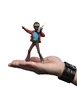 A small figurine of a character from Stranger Things is standing on a person's open palm. Produktbild-Vorschau
