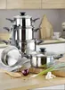 A set of stainless steel pots and pans stacked on a kitchen counter, with some ingredients like an onion and green onions in the foreground. Produktbild-Vorschau