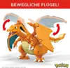 A model of a Charizard Pokemon made from building blocks is shown with its wings spread and indicated with arrows for movement. The Pokemon is depicted in a dynamic pose against a white background with some red text at the top and a Pokemon logo at the bot Voir les images du produit