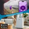 A woman holding a smartphone showing a humidity app, with a dehumidifier in a living room setting. Produktbild-Vorschau
