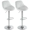 Two white bar stools with silver bases and adjustable height mechanisms are shown against a white background. Náhľad obrázku produktu