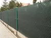 A dark green privacy screen fence along a paved walkway with concrete posts. Podgląd zdjęcia produktu
