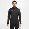 A man wearing a black Nike jacket and black pants against a white background. Produktbild-Vorschau