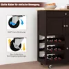 A dark brown kitchen cart with a wooden top, featuring a wine rack and drawers, shown with diagrams illustrating its wheels. Produktbild-Vorschau