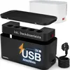 A black cable management box with a detachable power strip and lid, shown with a white appliance in the background. Produktbild-Vorschau