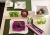 A table setting with plates, cutlery, glasses, and decorative items. Produktbild-Vorschau