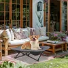 A corgi dog is resting on a raised pet bed on a patio. Produktbild-Vorschau