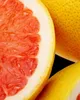 A close-up shot of a sliced grapefruit and another grapefruit. Voir les images du produit