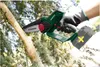 A person is using a cordless chainsaw to cut a tree branch. Produktbild-Vorschau