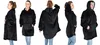 A collage of five images showing a woman from different angles wearing a black hooded blanket pullover. Produktbild-Vorschau
