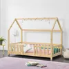 A child's house-shaped bed with wooden frame and railings, decorated with colorful pom-poms. Produktbild-Vorschau