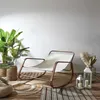 A rocking chair is set up on a wooden deck with plants and lanterns, creating a cozy outdoor living space. Voir les images du produit