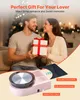 A couple is exchanging a gift in a festive setting, with a pottery wheel machine in the foreground. Produktbild-Vorschau