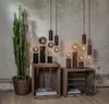 A collection of decorative Edison-style LED light bulbs displayed on wooden crates, with a tall cactus in a basket to the left. Podgląd zdjęcia produktu