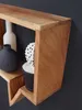 Close-up of a wooden wall shelf with decorative items. Produktbild-Vorschau