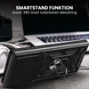 A black phone case with a ring stand is shown on a wooden surface, with a laptop and headphones in the background. Produktbild-Vorschau