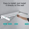 A hand is shown demonstrating how to install a wall-mounted drying rack. Produktbild-Vorschau