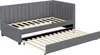 A gray upholstered daybed with a pull-out trundle bed is shown with the trundle extended. Náhľad obrázku produktu