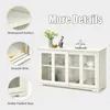 A white sideboard with glass sliding doors, decorated with a vase of flowers and a small figurine. Callouts highlight features like waterproof surface, smooth slide, and stable padded base. Podgląd zdjęcia produktu