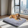 A dog is lying on a gray dog bed in front of a large window with a city view. Náhľad obrázku produktu