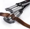 A close-up shot of a hair crimper with brown hair being styled. Náhľad obrázku produktu