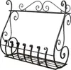 A black wrought iron wall-mounted shelf with decorative scrollwork. Náhľad obrázku produktu