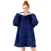 A woman wearing a dark blue oversized hoodie. Produktbild-Vorschau