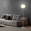 A modern living room with a gray sofa and a floor lamp. Produktbild-Vorschau