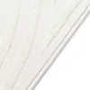 A close-up view of a white textured rug with a stitched edge. Anteprima dell’immagine prodotto