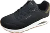 A black Skechers sneaker with a white sole and brown outsole is shown from the side against a white background. Voir les images du produit