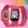 A pink smartwatch for children is displayed against a soft pink and pastel background. Produktbild-Vorschau