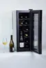 A wine cooler with its door open, showing bottles inside. A wine bottle and a glass of wine are placed next to it. Voir les images du produit