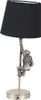A table lamp with a black lampshade and a silver-colored monkey figure climbing a pole as the base. Produktbild-Vorschau