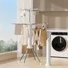 A laundry room with a drying rack and a washing machine. Anteprima dell’immagine prodotto