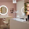 A beauty salon or dressing room setting with makeup products and decorative lights. Podgląd zdjęcia produktu