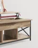 A person's hand is shown lifting the top of a coffee table. Náhled obrázku produktu
