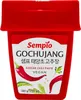A red container of Sempio Gochujang Korean Chili Paste with illustrations of chili peppers and parsley. Podgląd zdjęcia produktu