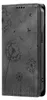 A black flip-style phone case with a debossed dandelion design. Produktbild-Vorschau