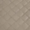 A close-up view of quilted fabric with a diamond pattern. Produktbild-Vorschau
