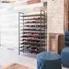 A modern interior with a large metal wine rack filled with bottles, set against a textured wall. Náhľad obrázku produktu