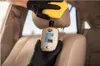 A person wearing black gloves is cleaning a car seat with a yellow cloth, while holding a bottle of K2 LETAN cleaner. Podgląd zdjęcia produktu