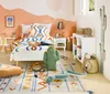 A child's bedroom decorated in a desert theme, featuring a bed with patterned bedding, a small desk and chair, and various decorative items. Náhled obrázku produktu