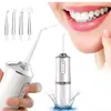 A close-up shot of a person's mouth using a water flosser, with the product and its accessories displayed. Náhľad obrázku produktu
