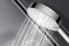A close-up shot of a chrome shower head with water spraying from it. Náhľad obrázku produktu