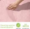 A hand touching a pink textured fabric, with marketing icons and text at the bottom. Produktbild-Vorschau