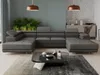 A modern living room with a large sectional sofa, coffee table, plants, and a credenza. Produktbild-Vorschau