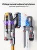A cordless vacuum cleaner is shown mounted on its wall charging station, with additional accessories docked below. Podgląd zdjęcia produktu