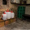 A cellar or basement storage area with fermentation or storage containers. Anteprima dell’immagine prodotto