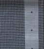 A close-up view of a white Leno tarp with a grid pattern and three small holes. Náhled obrázku produktu